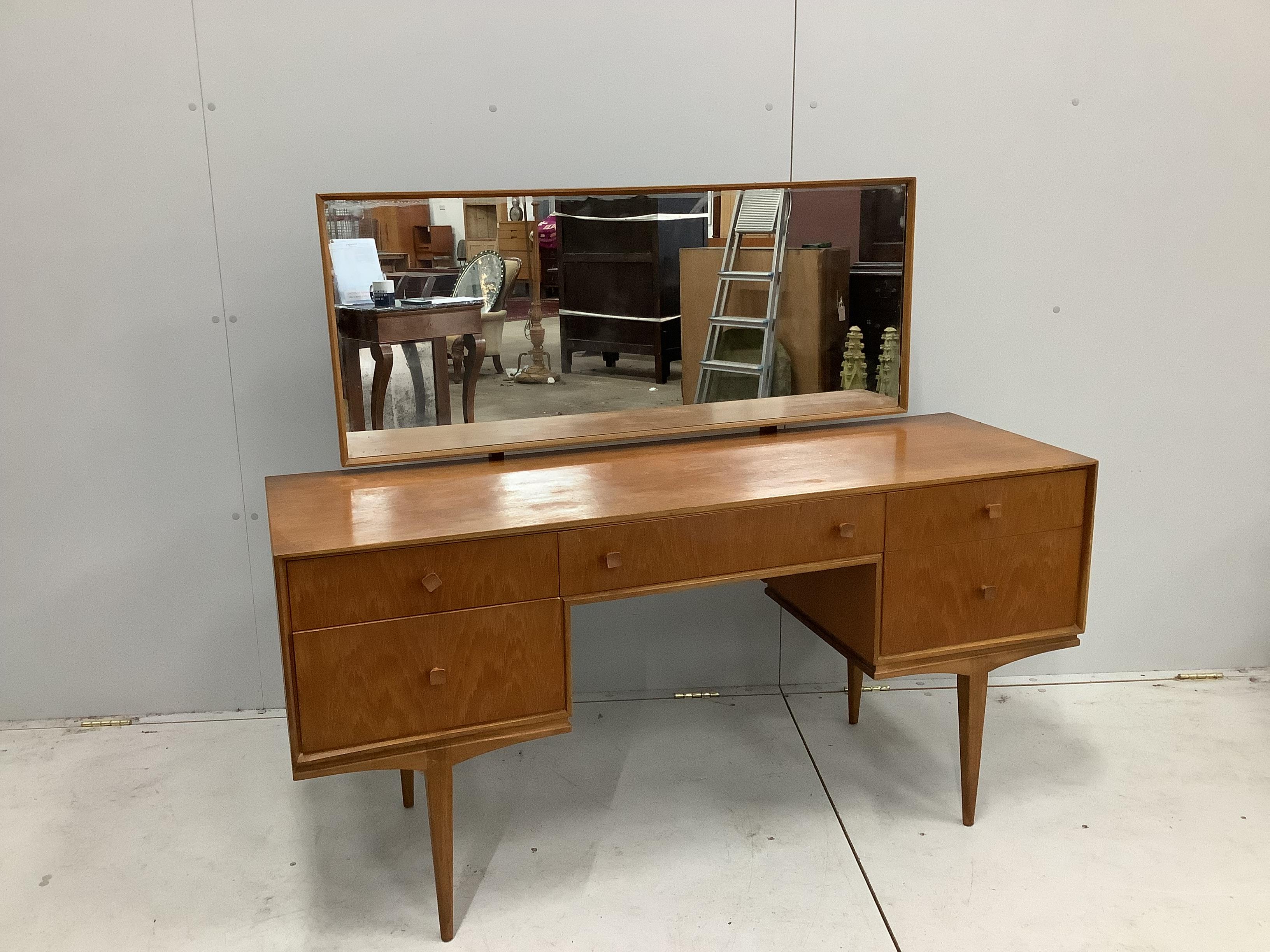 McIntosh of Kirkaldy, a mid century teak kneehole dressing table, width 141cm, depth 46cm, height 117cm together with a matching headboard with integral cupboards